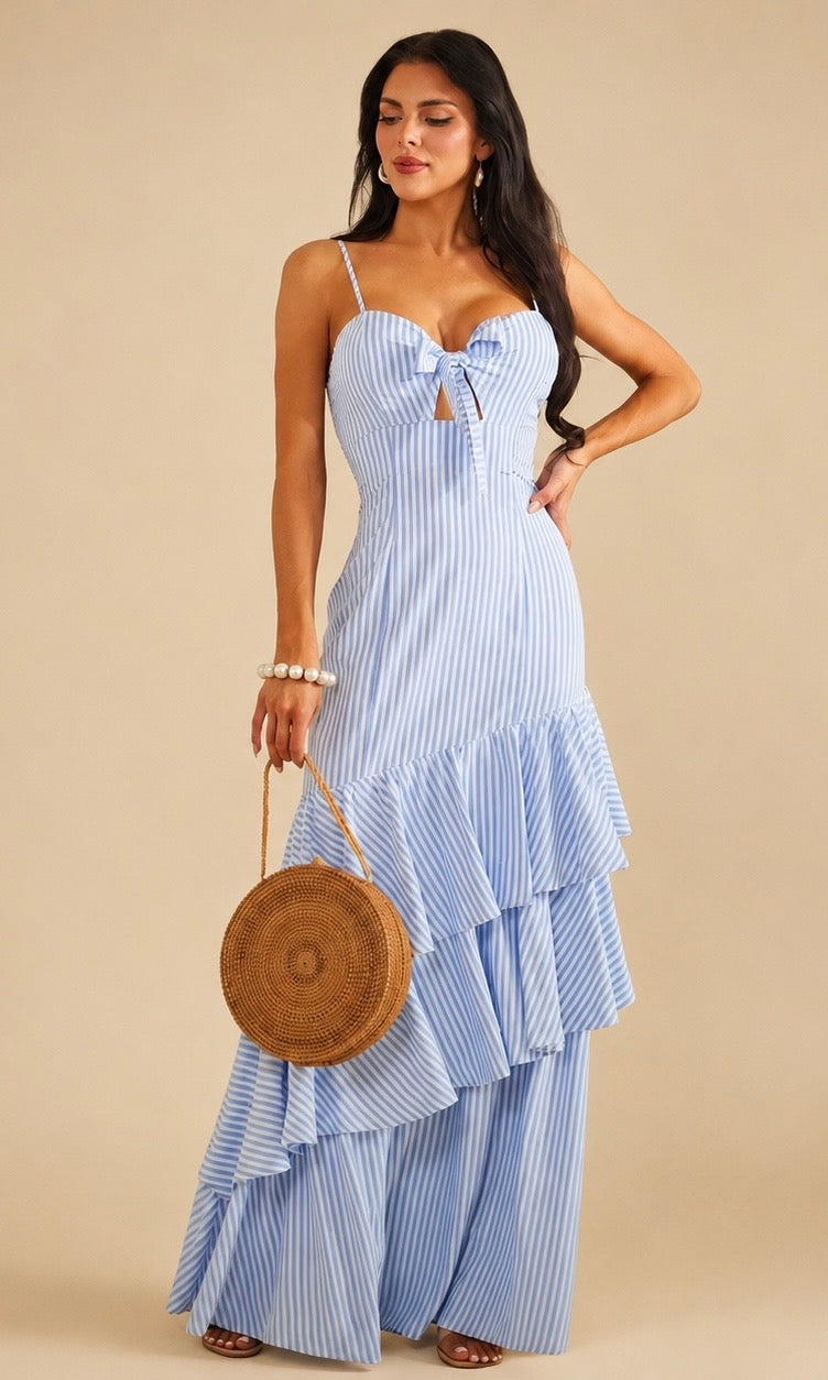 Blue and white striped maxi dress features a ruffled tiered skirt, a tied bust cut-out, and spaghetti straps